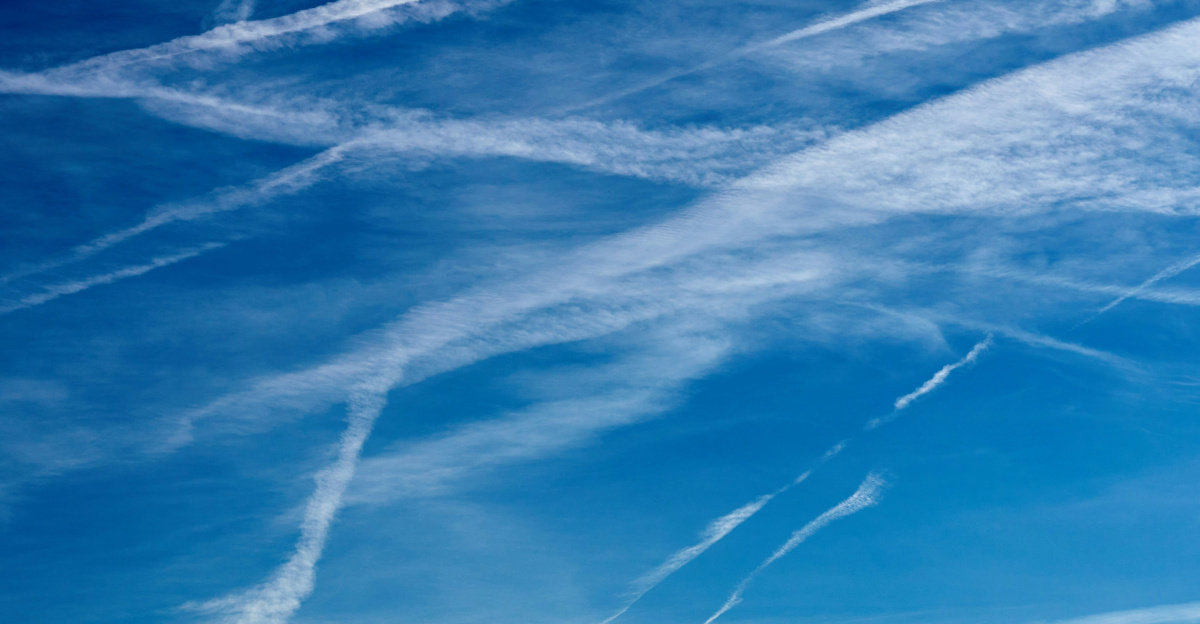 a blue sky with some contrails in the sky