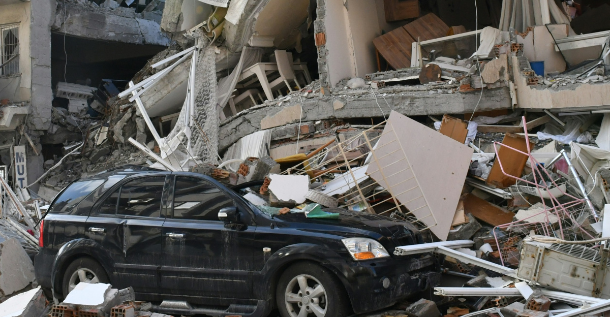 a car is parked in front of a destroyed building