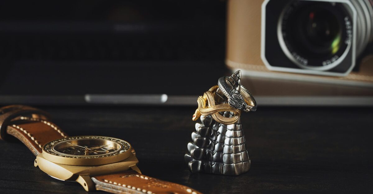 a camera and a watch on a table
