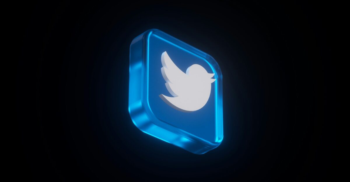 a lit up twitter logo in the dark