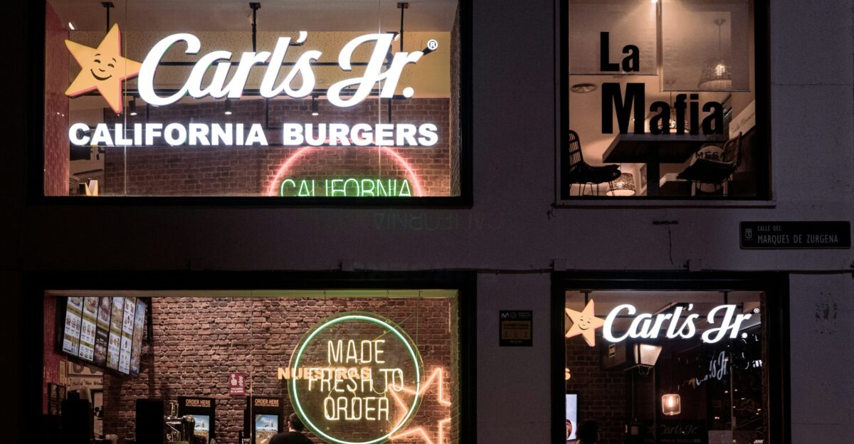 a store front with neon signs in the windows
