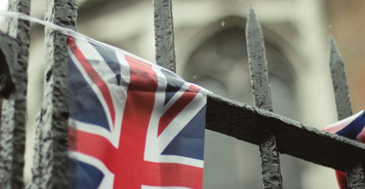 a union jack flag hanging on a fence