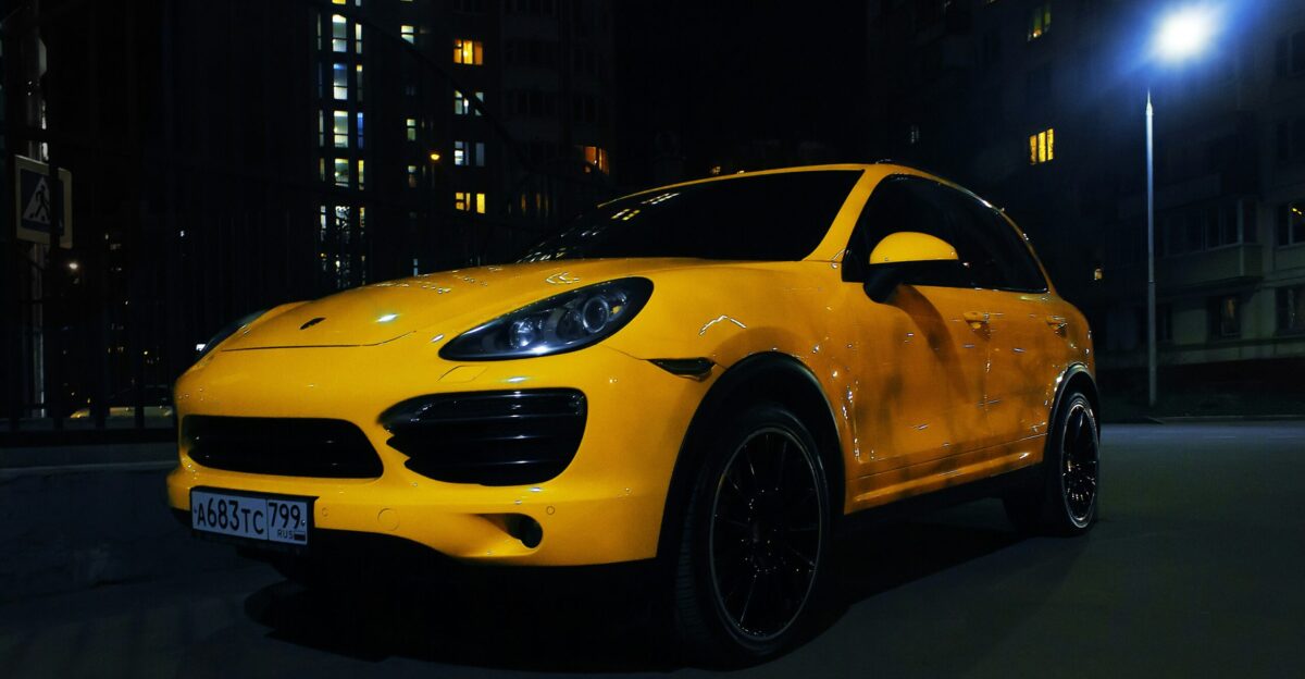 a yellow car parked on the street at night