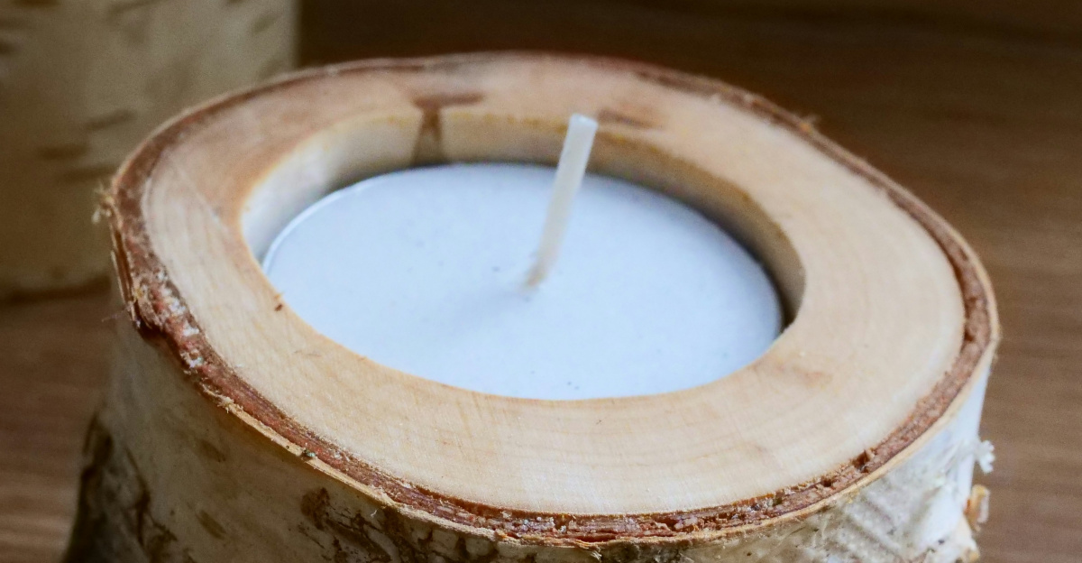 a wooden candle holder sitting on top of a wooden table