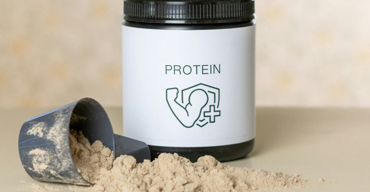 a jar of protein powder next to a scoop of powder