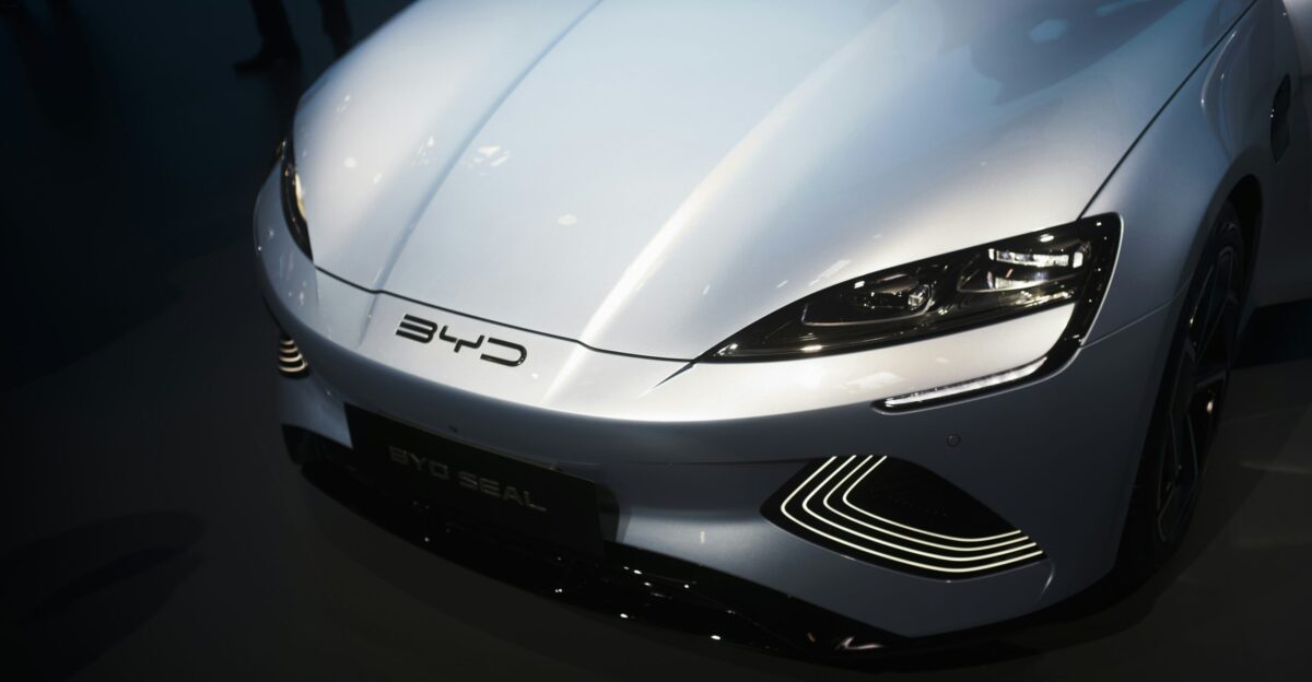 a white sports car is on display at a car show