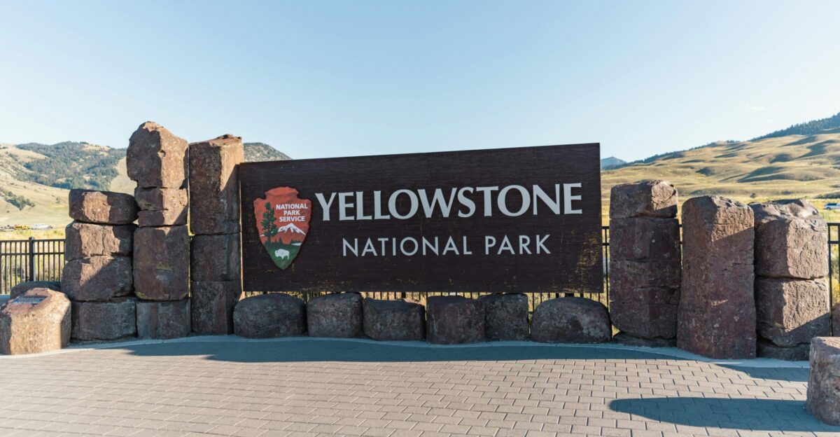 a sign for yellowstone national park on a sunny day