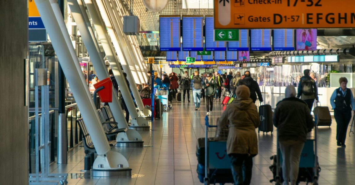 a group of people walking through an airport