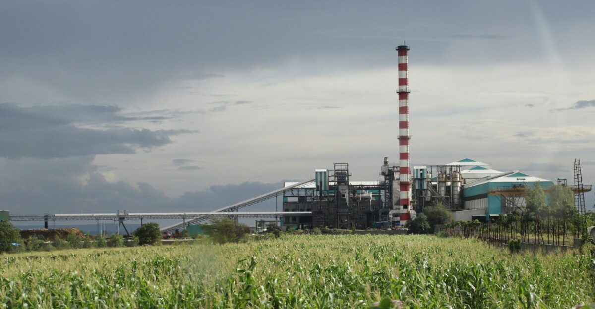 a factory with a large pipe sticking out of it s side