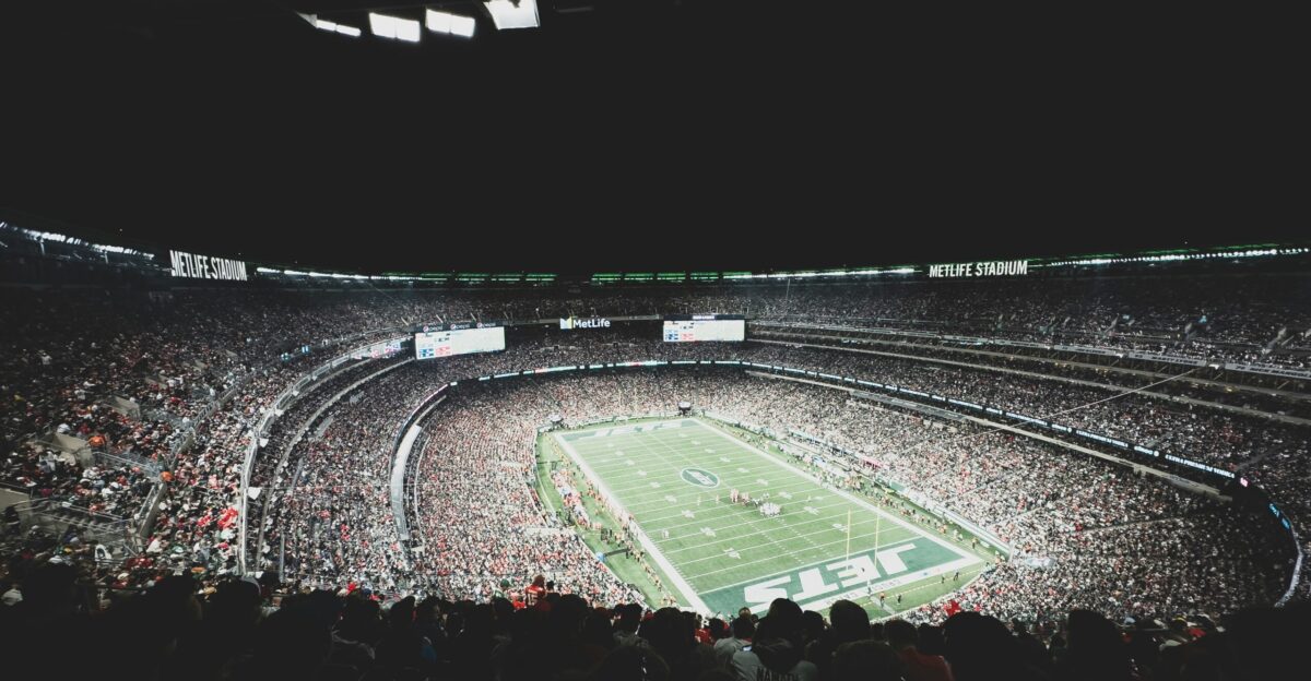 a stadium filled with lots of people watching a football game