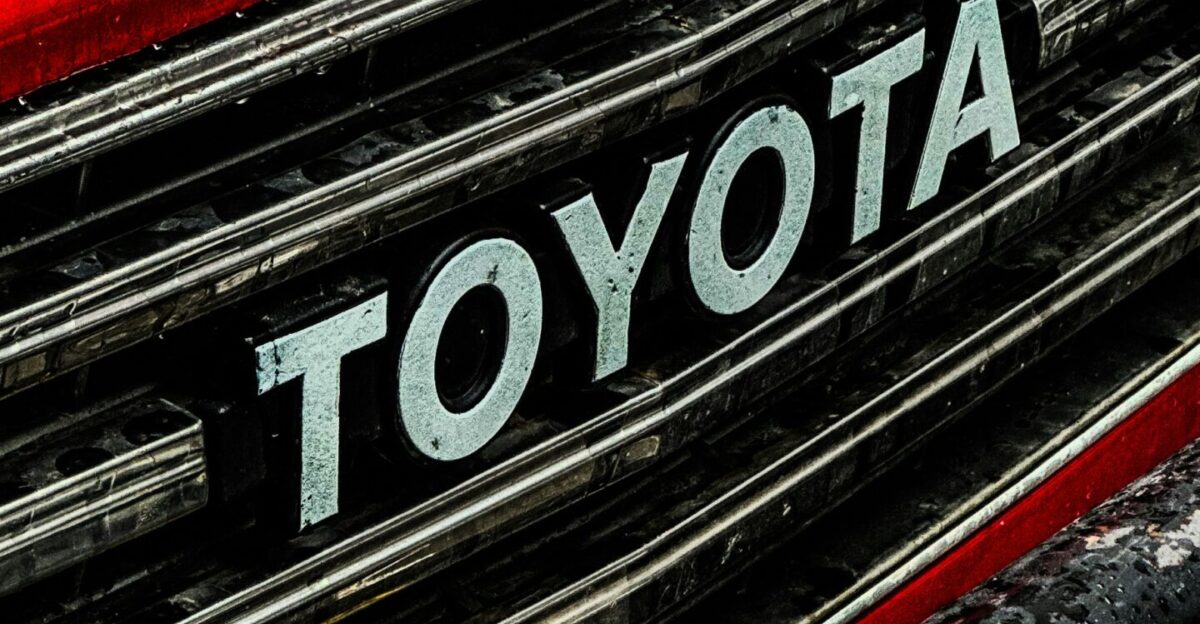 a close up of a toyota logo on a red car