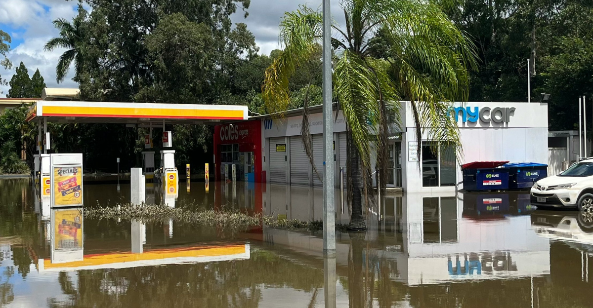 a flooded gas station with cars parked in it