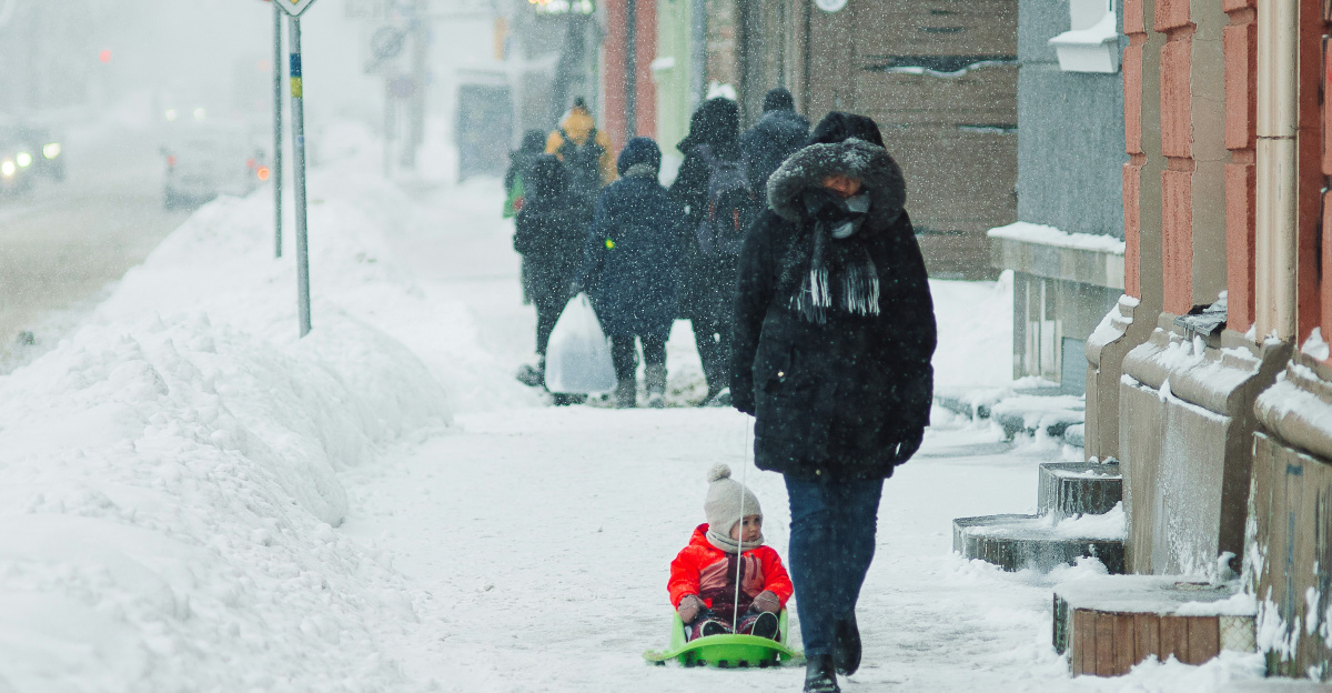 a group of people walking down a snow covered street