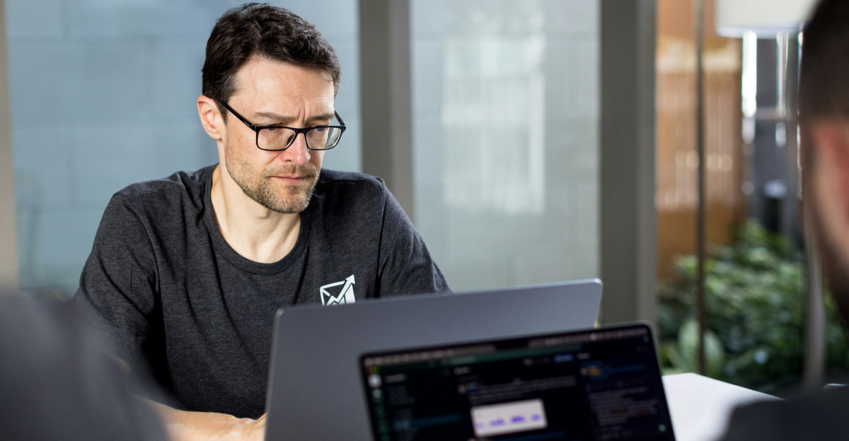 a man sitting in front of a laptop computer