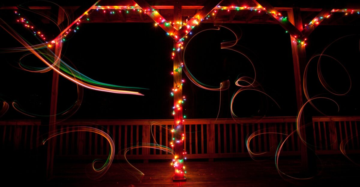 a lit up tree in the dark with lights on it