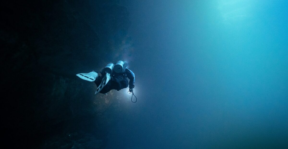 a man in a wet suit diving in the water