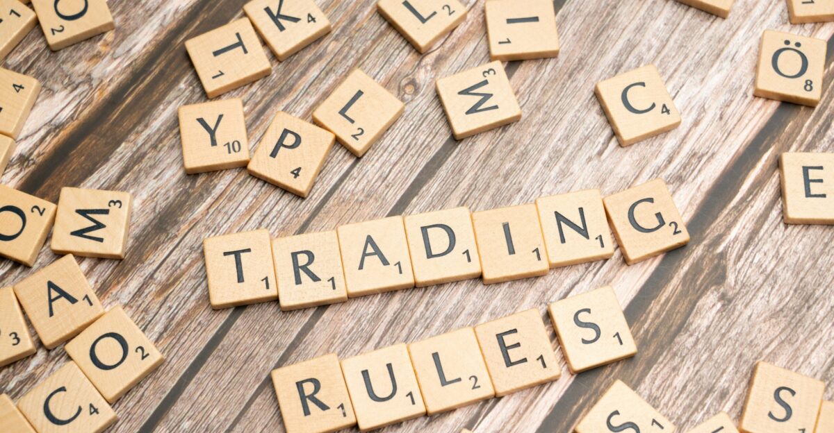 scrabble tiles spelling trading rules on a wooden table