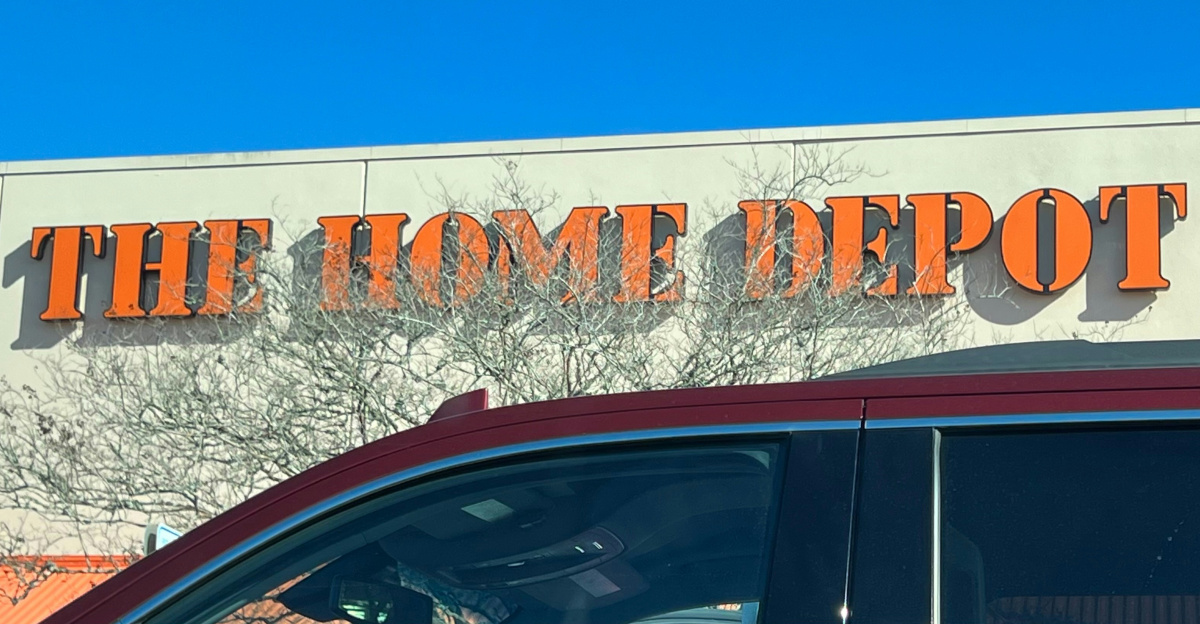 a red car parked in front of a home depot