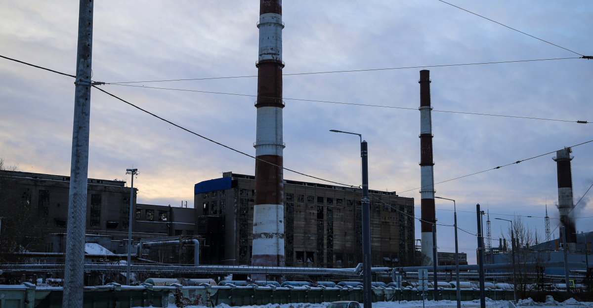 a factory with a lot of power lines in the background