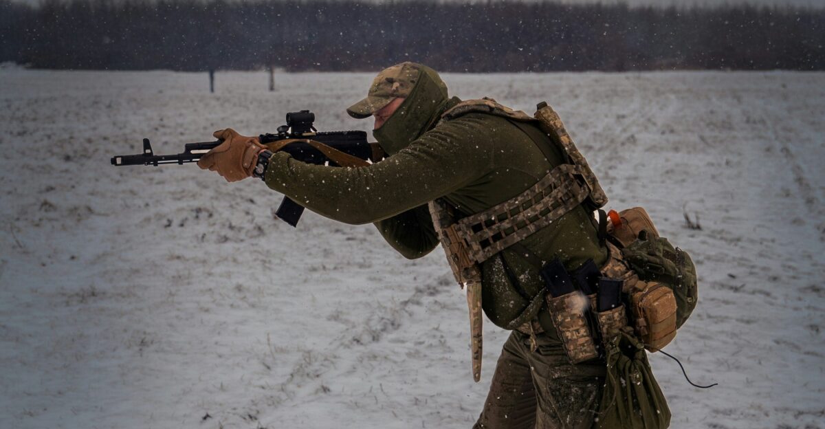 a man with a rifle in the snow
