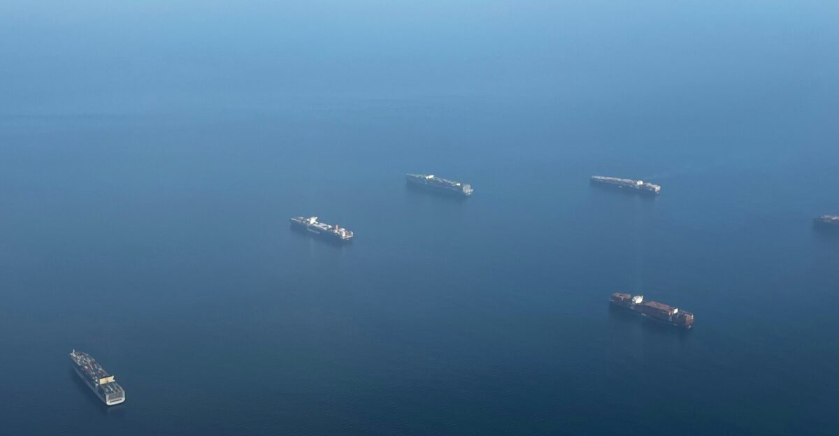 a group of ships floating on top of a body of water