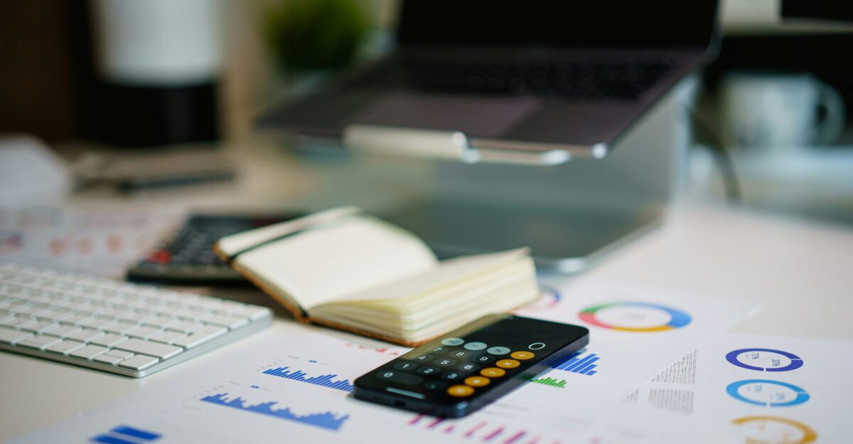 a remote control sitting on top of a table next to a book