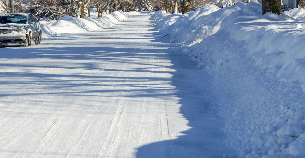 a car driving down a snow covered road