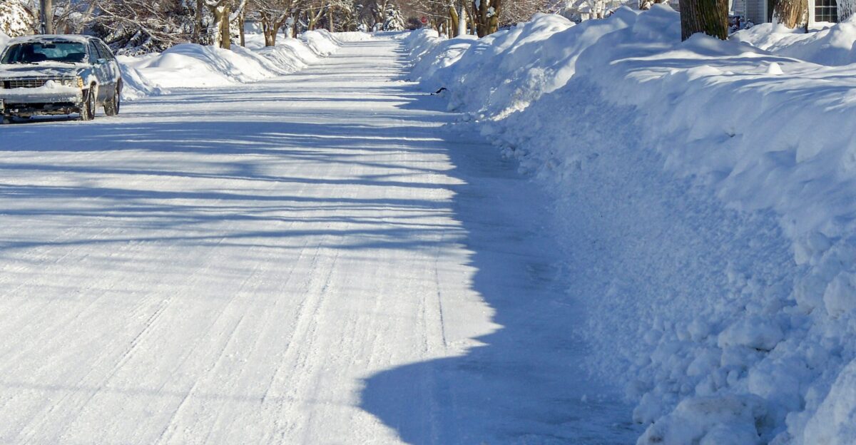 a car driving down a snow covered road