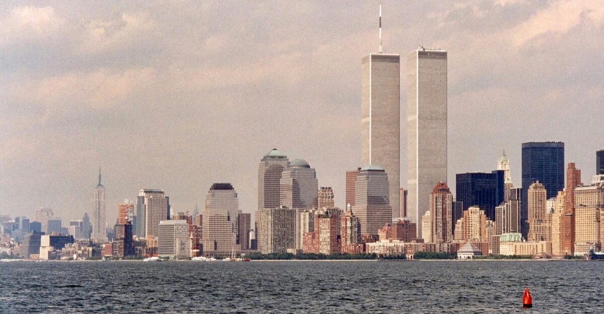 a large body of water with a city in the background