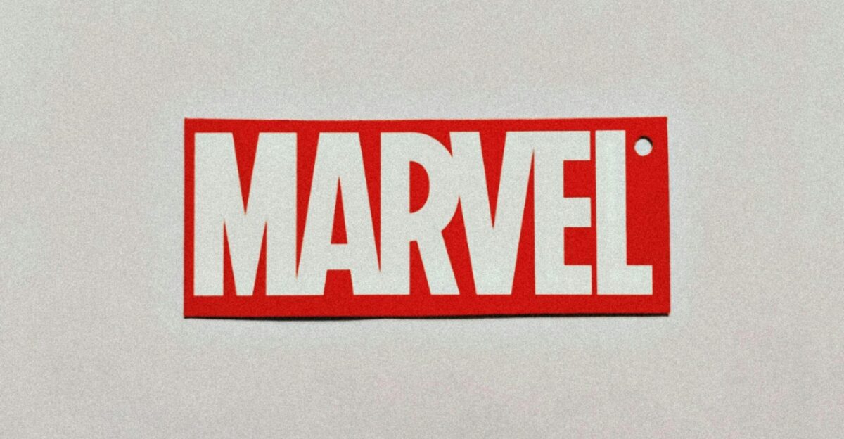 a red and white sticker with the word marvel on it