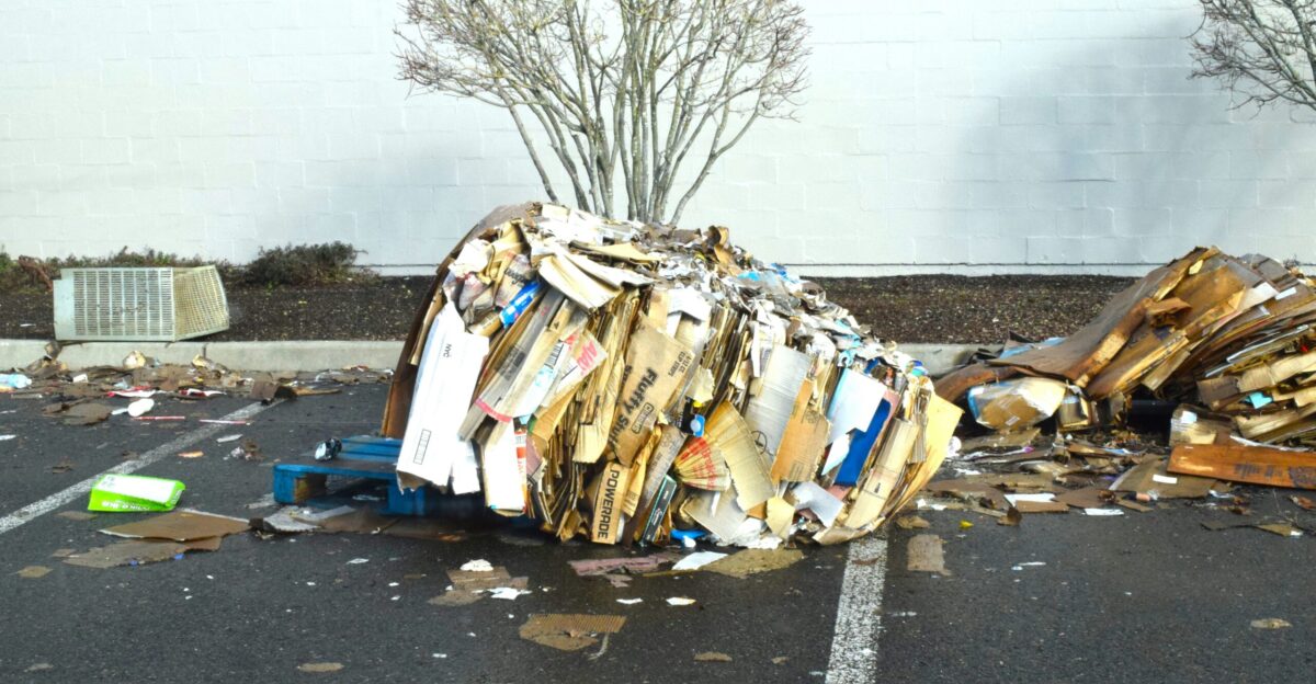 a pile of trash sitting on the side of a road