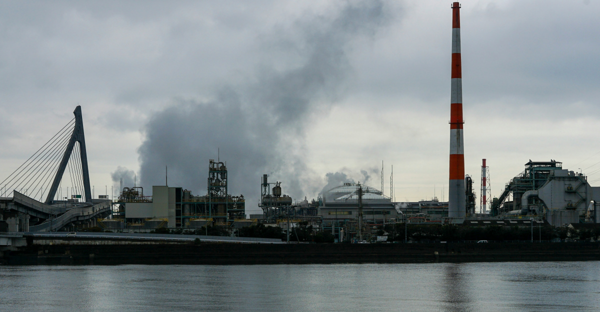 a factory with smoke coming out of it's stacks