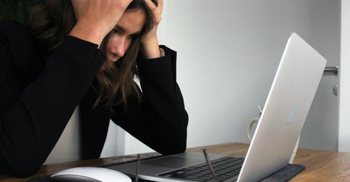 a woman sitting in front of a laptop computer