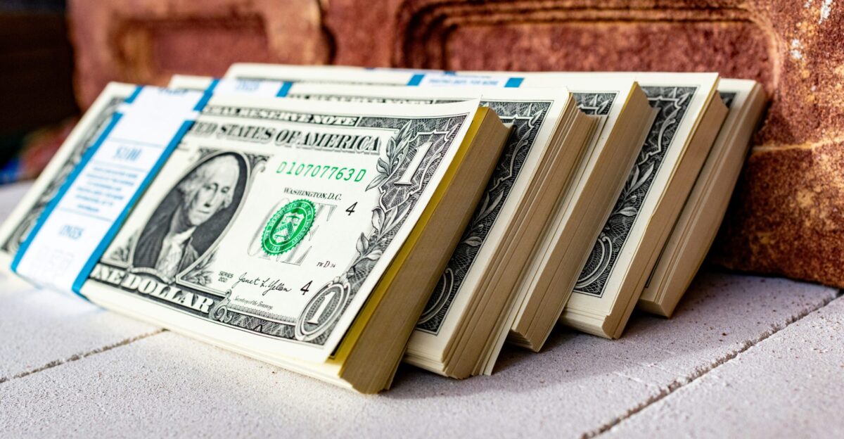 a stack of money sitting on top of a table