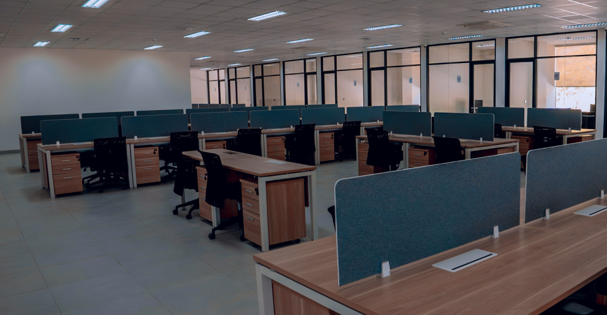 an empty office space with desks and chairs