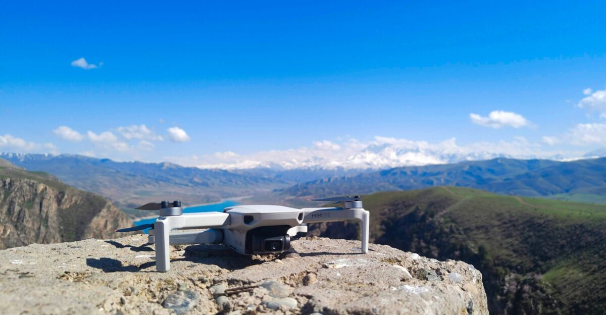 a remote controlled flying device on top of a mountain