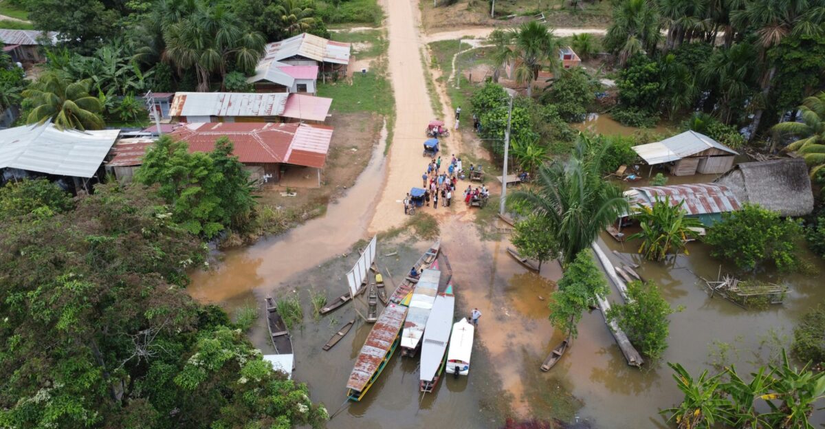 An aerial view of a village with boats in the water