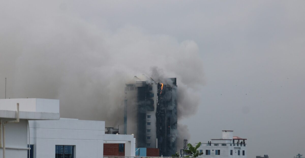 Smoke billows from a building in a city