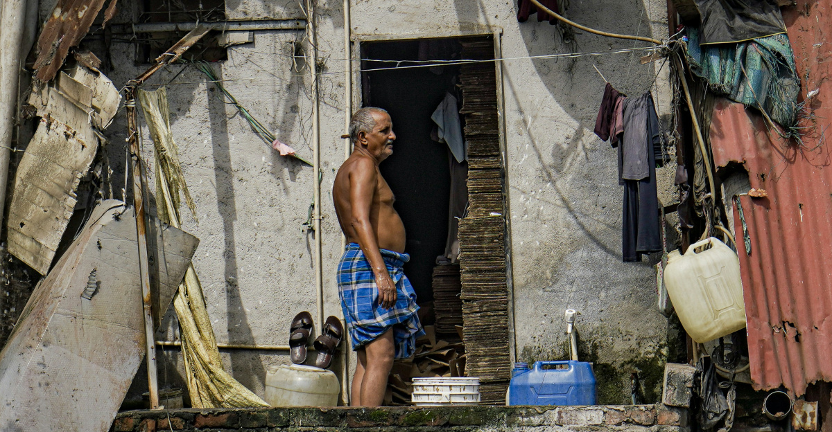 A man standing in the doorway of a shack