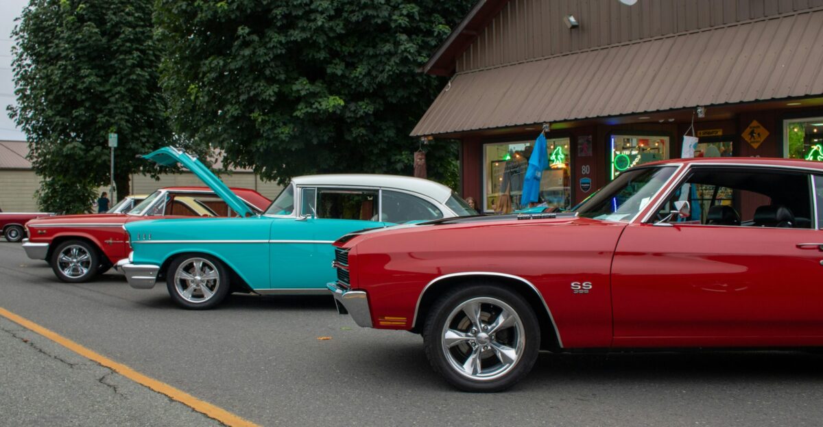 A row of classic cars parked in front of a building