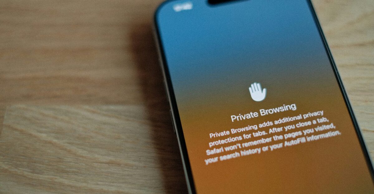 A cell phone sitting on top of a wooden table