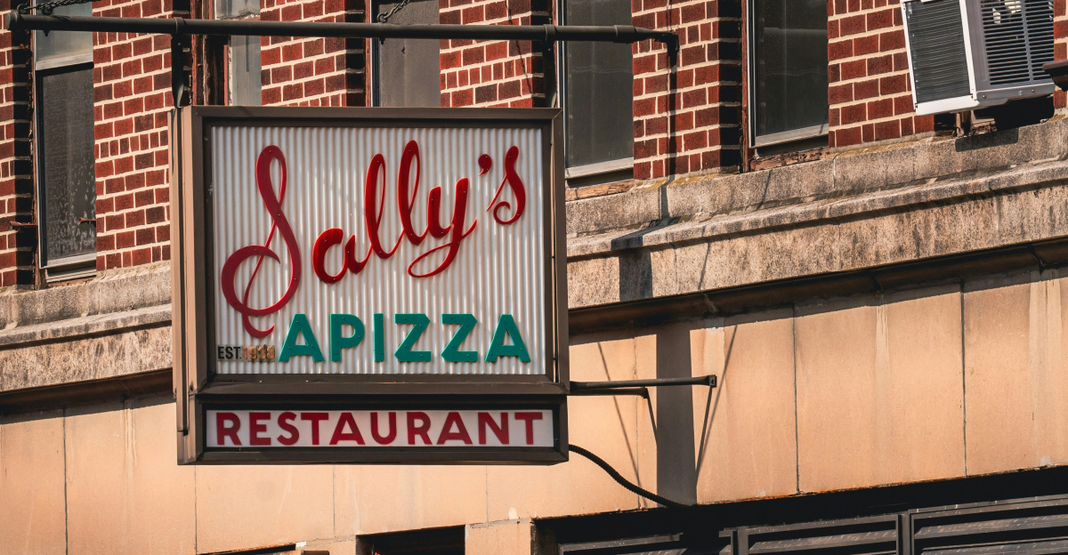A restaurant called salty's pizza on the corner of a street