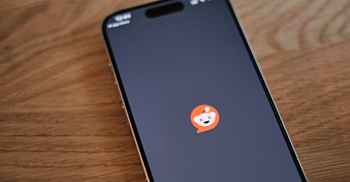 A cell phone sitting on top of a wooden table