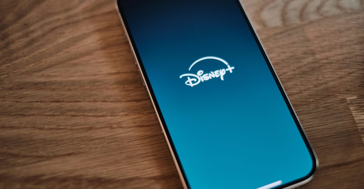 A cell phone sitting on top of a wooden table