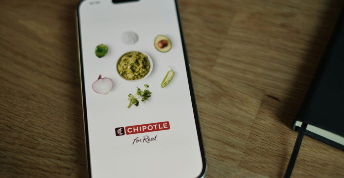 A cell phone sitting on top of a wooden table