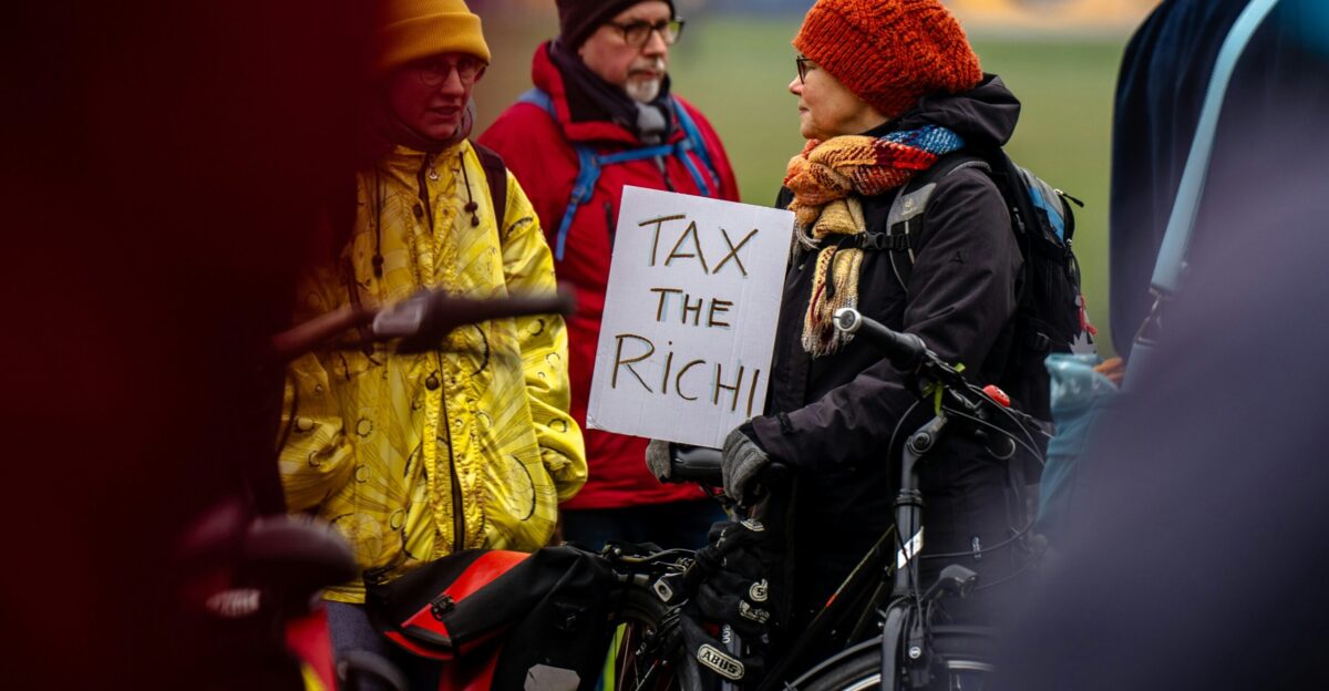 A person in a wheelchair holding a sign