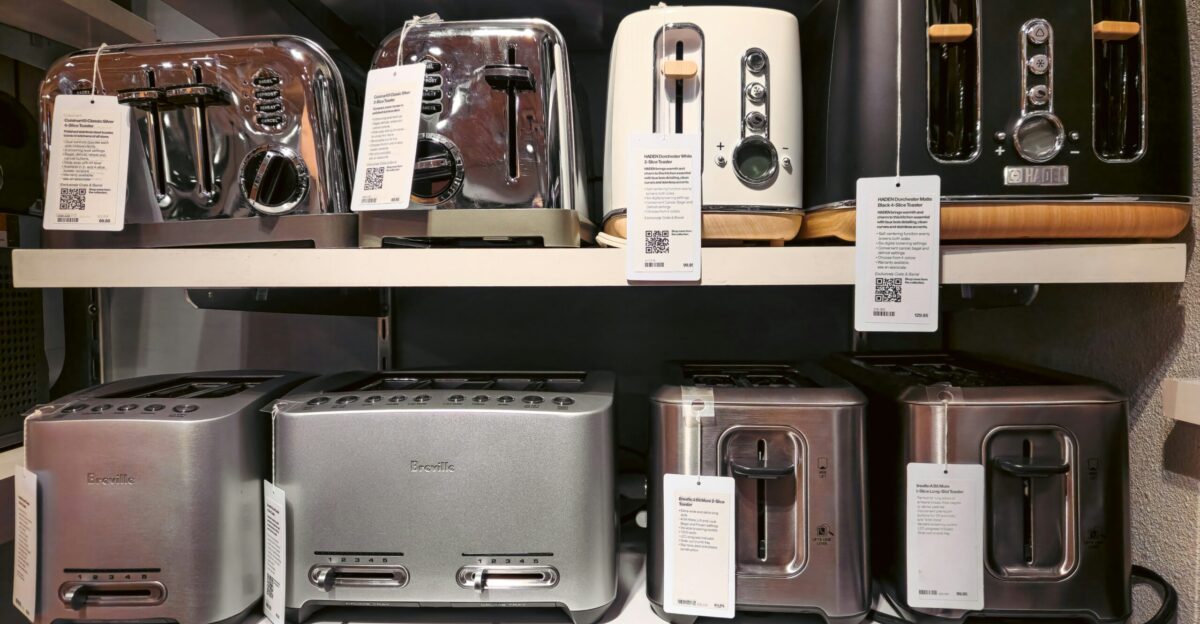 A bunch of toasters that are on a shelf