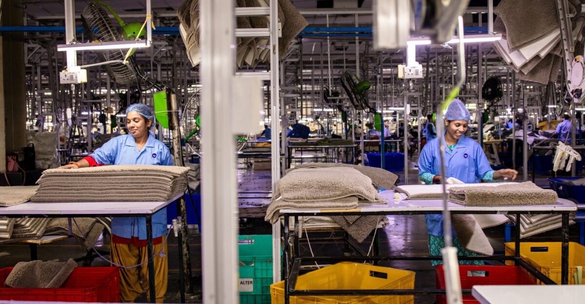 Factory workers busy at their production stations