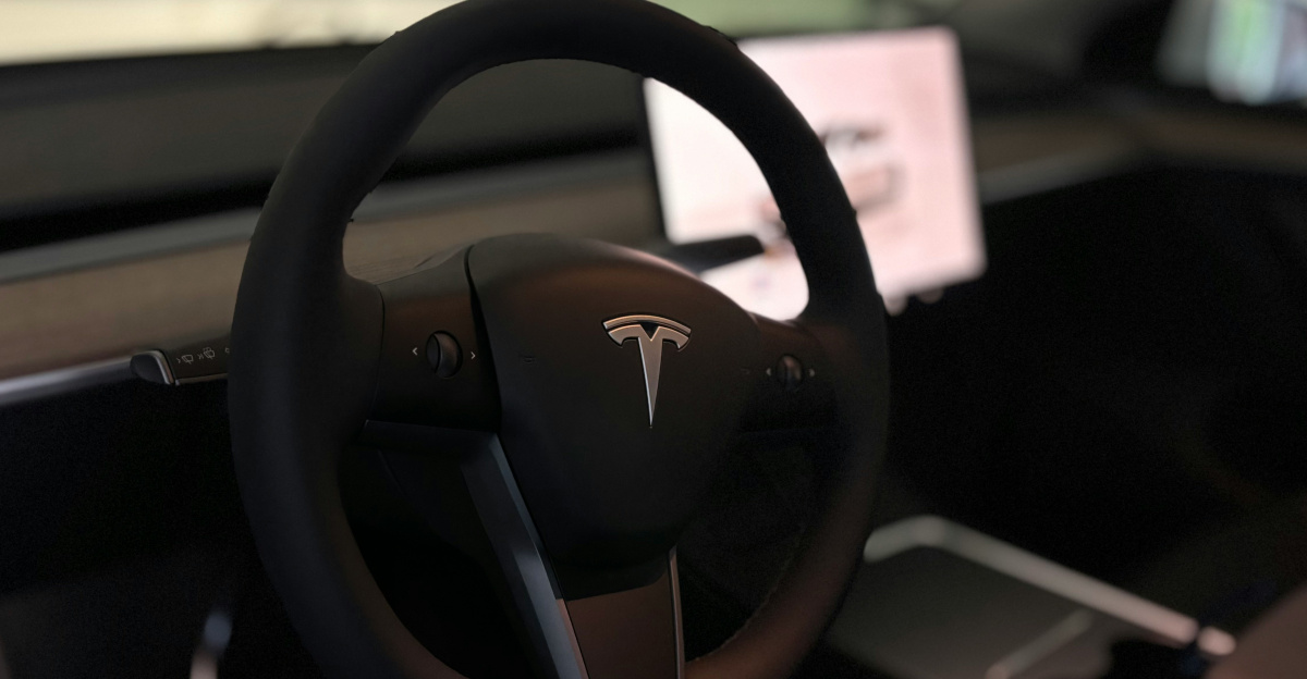 A tesla's steering wheel and interior.