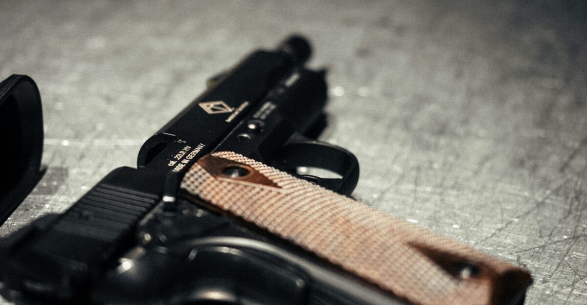 A handgun rests on a surface